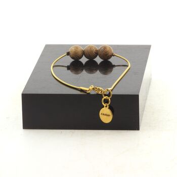Golden stainless steel bracelet 3 wood 8 mm Beads.