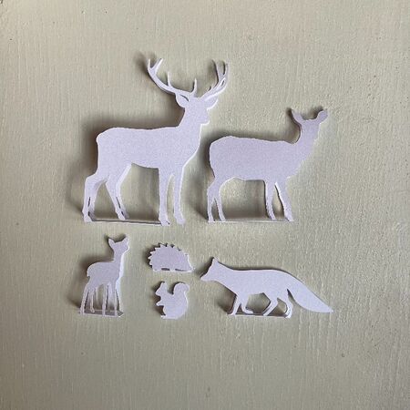 Set of animals made in white paper