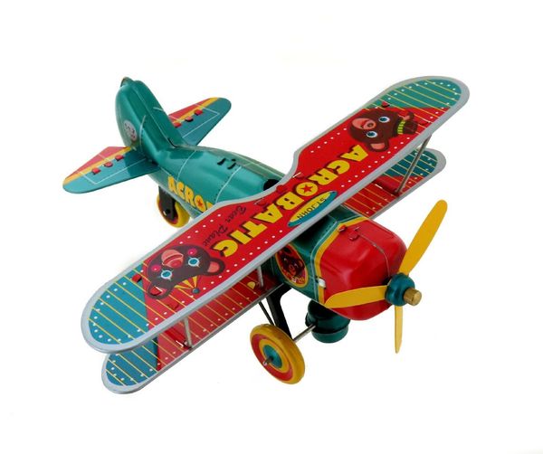 Jouet mécanique en métal (fer blanc) représentant un avion à hélice Jouet mécanique en métal (fer blanc) représentant un avion à hélice