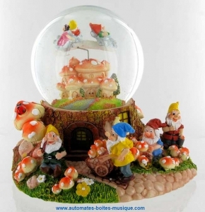 Musical snow globe made of polystone : sparkling snow globe with Snow White and two dwarfs flying on a mushroom village.