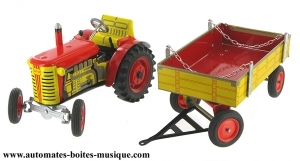 Collectable mechanical tin toy : tractor and trailer made of sheet metal and tin.