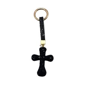 Porte-clés en forme de croix recouverte de strass étincelants