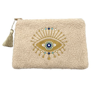 Petite trousse moutonnée avec un motif central brodé d'un œil