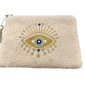 Petite trousse moutonnée avec un motif central brodé d'un œil