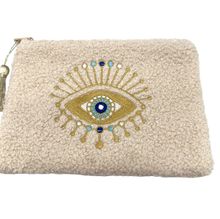 Petite trousse moutonnée avec un motif central brodé d'un œil