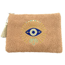 Petite trousse moutonnée avec un motif central brodé d'un œil