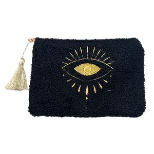 Petite trousse moutonnée avec un motif central brodé d'un œil
