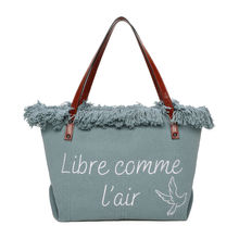 Cabas zippé "Libre comme l'air" et un oiseau accentué par des franges