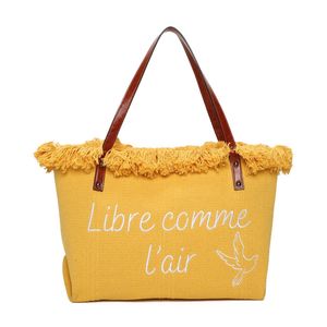 Cabas zippé "Libre comme l'air" et un oiseau accentué par des franges