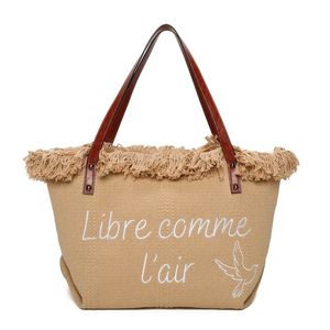 Cabas zippé "Libre comme l'air" et un oiseau accentué par des franges