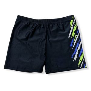 Short de bain court uni à motif graphique abstrait sur le côté droit