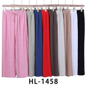 Pantalon fluide palazzo plissé et froissé créant un effet ondulé