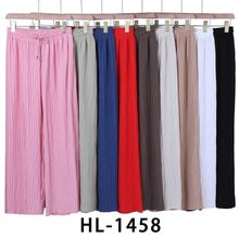 Pantalon fluide palazzo plissé et froissé créant un effet ondulé