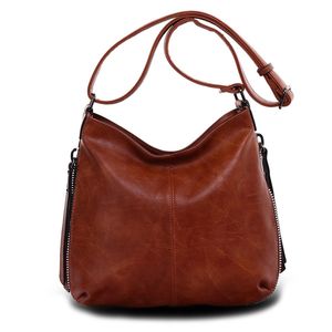 Besace en cuir synthétique avec des zips latéraux décoratifs