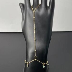 Bracelet bague orné de perles variées et d'un pendentif discret