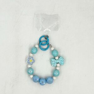 Dragonne de téléphone en perles facettées avec breloques fleur et nœud