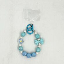 Dragonne de téléphone en perles facettées avec breloques fleur et nœud