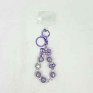 Dragonne de téléphone en perles avec nœud papillon, cœur et fleur pastel