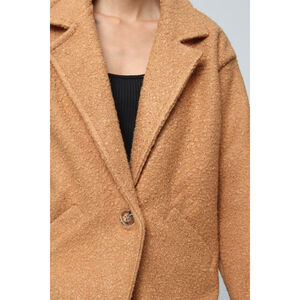 Manteau boutonné en tissu bouclée doté de poches pratiques