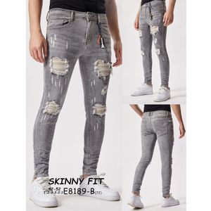 Pantalon jean gris skinny à léger délavage avec des déchirures