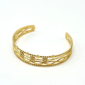 Bracelet Jonc avec plusieurs bandes à différents motifs en acier dorée
