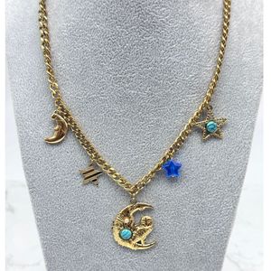 Collier doré à breloques design évoquant le thème céleste et cosmique