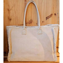 Sac à épaule en suédine orné d'une bordure en moumoute blanche