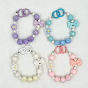 Dragonne de téléphone en perles facettées avec breloques fleur et nœud