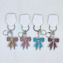 Porte-clés avec un charmant nœud papillon stylisé strass argenté