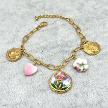 Bracelet en acier inoxydable doré à breloques floraux émaillés et médaillons gravés